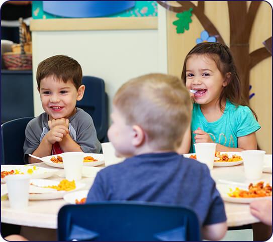 Kids sitting at a table and eating at our Preschool Near Lakewood Ranch