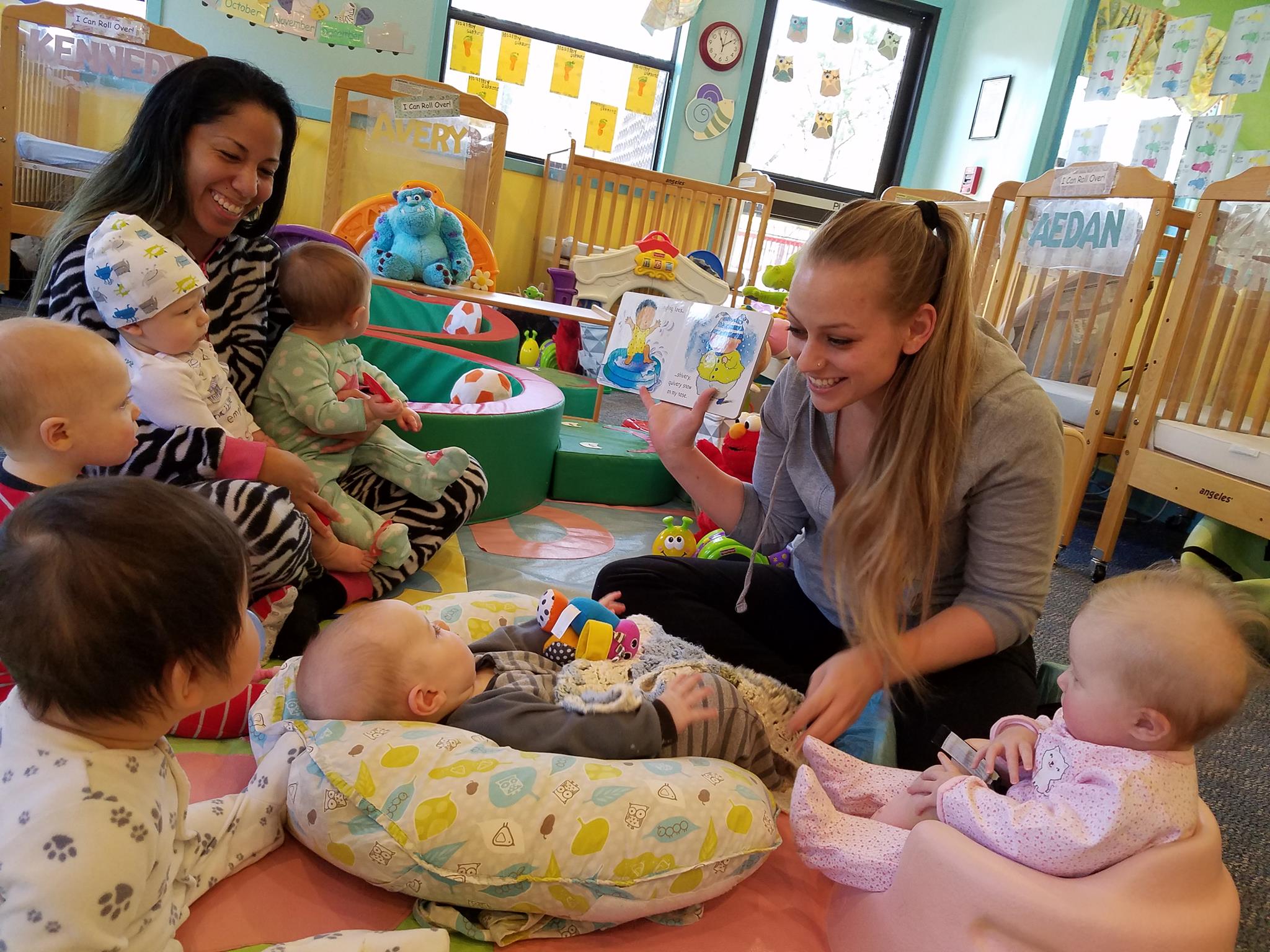 Teacher reading a book to infant during infant care in Porterdale.