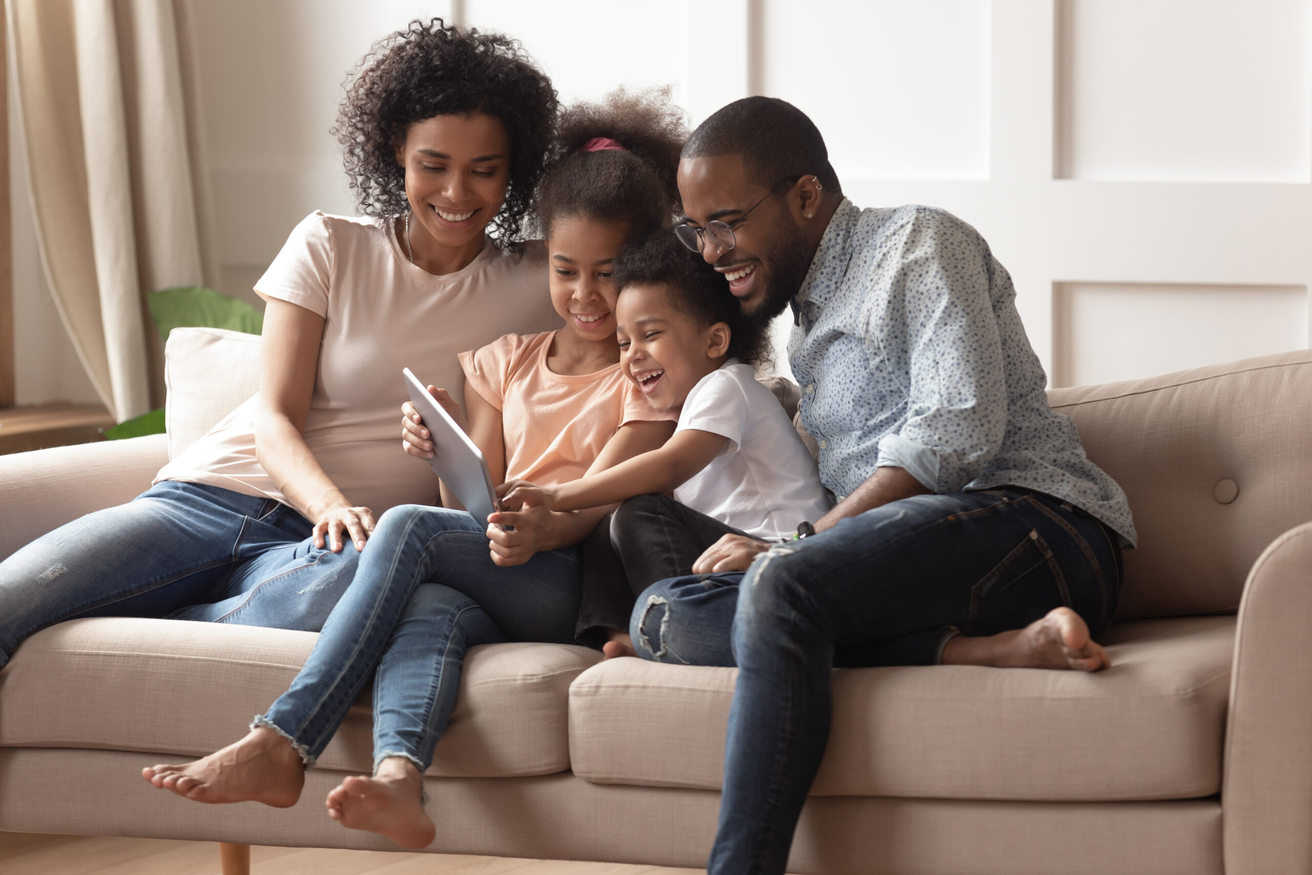 family reading book on couch